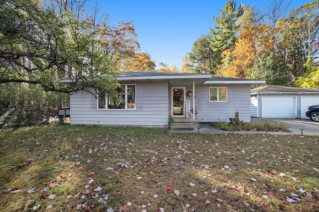 ranch-style house with a garage, an outbuilding, and a front lawn