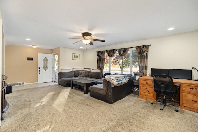 carpeted home office featuring ceiling fan