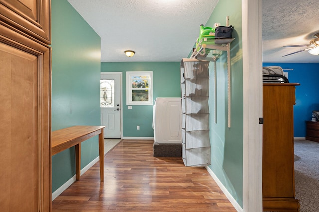 bathroom with hardwood / wood-style floors, ceiling fan, and a textured ceiling