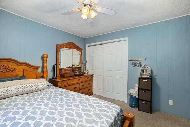 carpeted bedroom with a textured ceiling, a closet, and ceiling fan