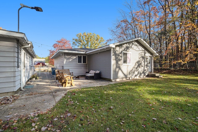 back of house featuring a lawn and a patio area