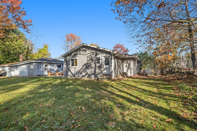 rear view of house featuring a lawn