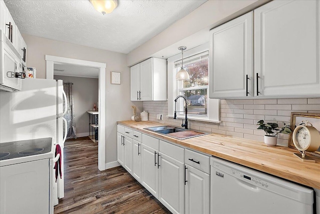 kitchen with sink, dark hardwood / wood-style floors, decorative light fixtures, white appliances, and white cabinets