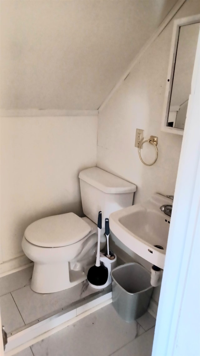 bathroom with tile patterned flooring, toilet, and sink