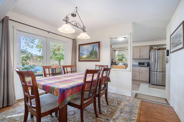dining space with light hardwood / wood-style flooring