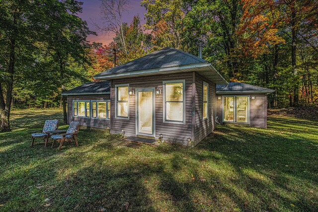 back house at dusk with a yard