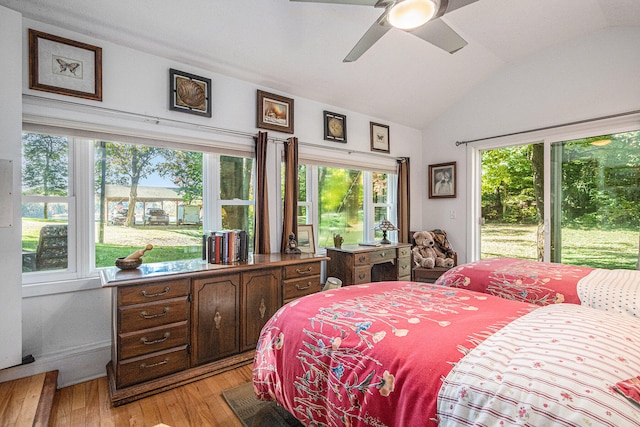 bedroom featuring ceiling fan, light hardwood / wood-style floors, and lofted ceiling