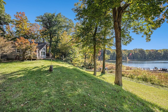 view of yard with a deck with water view