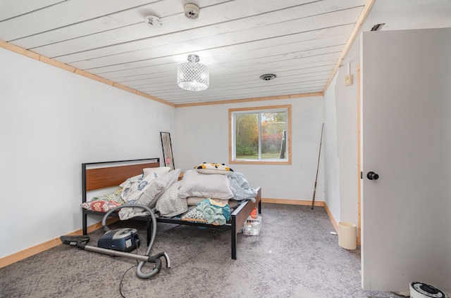 carpeted bedroom featuring wooden ceiling and ornamental molding