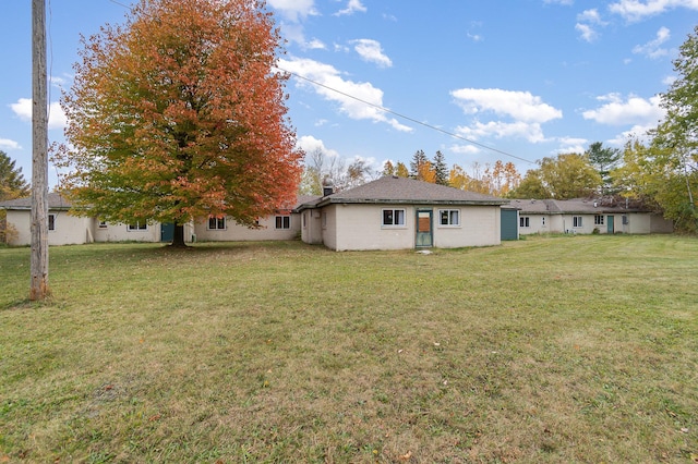 back of house with a lawn