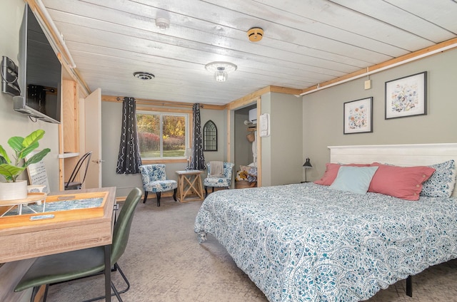 carpeted bedroom with wood ceiling