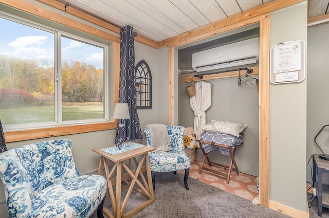 sitting room with a wall unit AC, a wealth of natural light, carpet floors, and wood ceiling