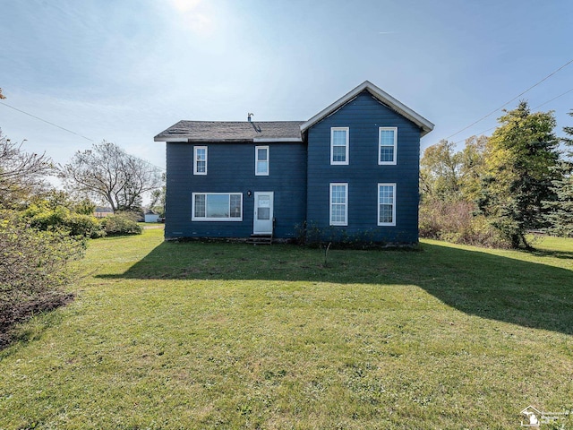 back of house featuring a yard