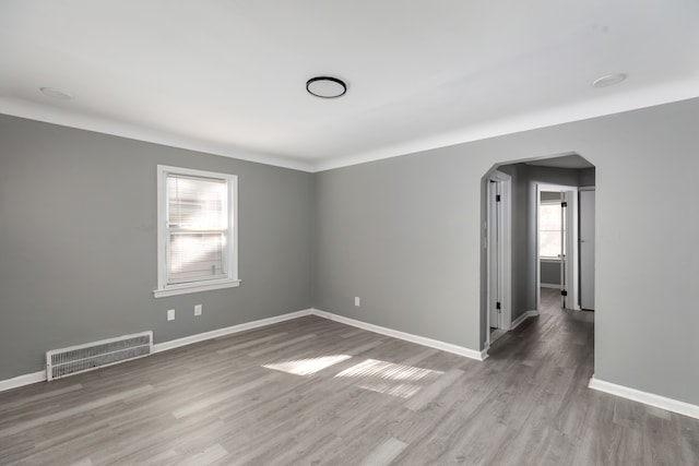 unfurnished room with wood-type flooring and plenty of natural light