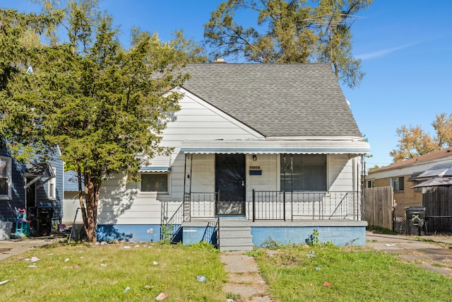 bungalow featuring a front yard and covered porch