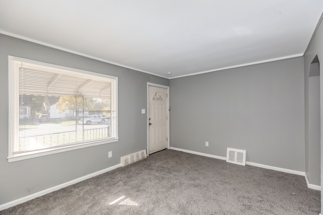 carpeted empty room featuring ornamental molding