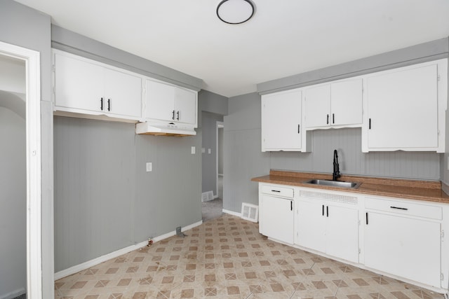 kitchen with white cabinetry and sink