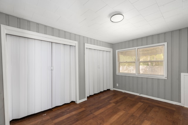 unfurnished bedroom featuring dark hardwood / wood-style flooring