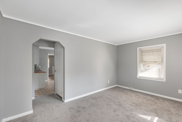 carpeted empty room with ornamental molding