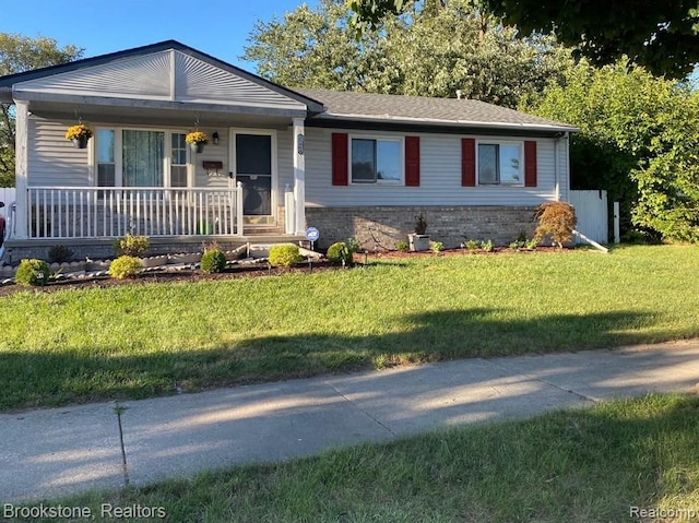 ranch-style house with a porch and a front lawn