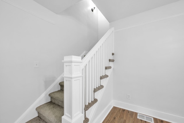 stairs featuring wood-type flooring