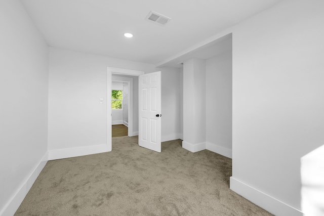 unfurnished room with light carpet