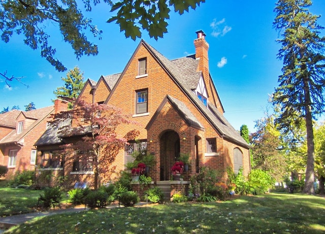 tudor-style house with a front lawn