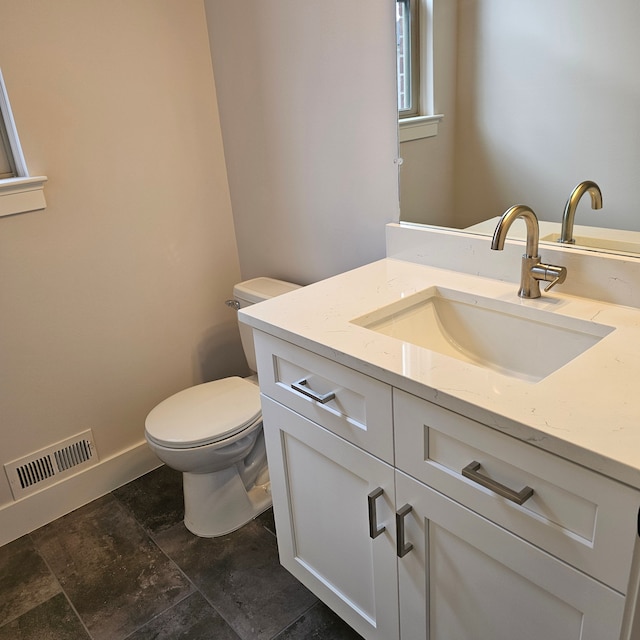 bathroom featuring toilet and vanity