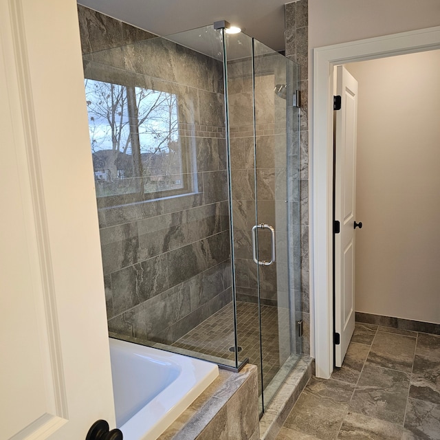 bathroom featuring shower with separate bathtub