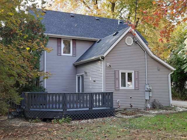 rear view of house featuring a wooden deck