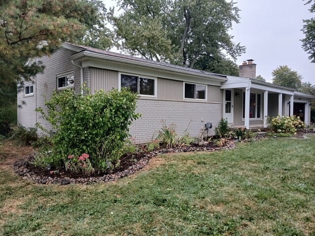 28164 Kendallwood Dr, Farmington Hills, MI 48334 - ranch-style home featuring brick siding, a chimney, and a front yard