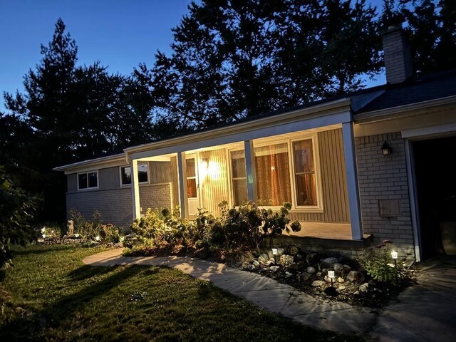 28164 Kendallwood Dr, Farmington Hills, MI 48334 - view of front of home featuring brick siding, a chimney, and a front lawn