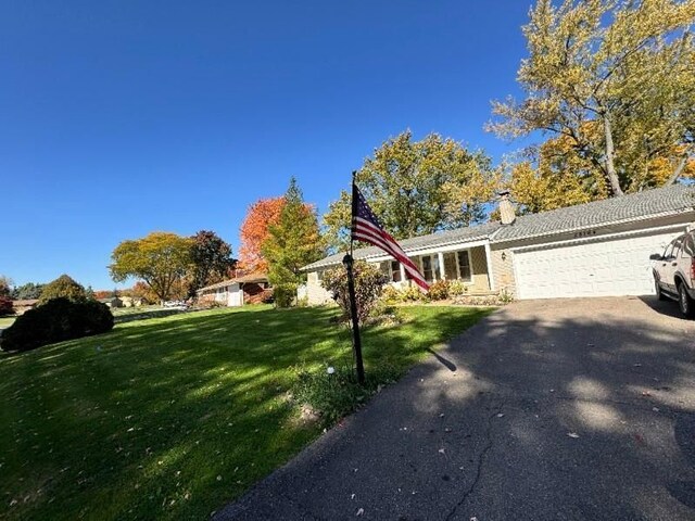 28164 Kendallwood Dr, Farmington Hills, MI 48334 - view of front of property with a garage, a chimney, a front lawn, and driveway