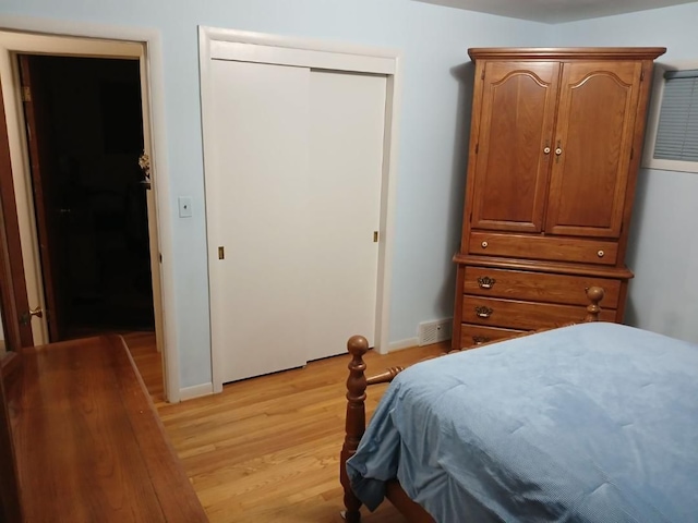 bedroom featuring a closet and light hardwood / wood-style flooring