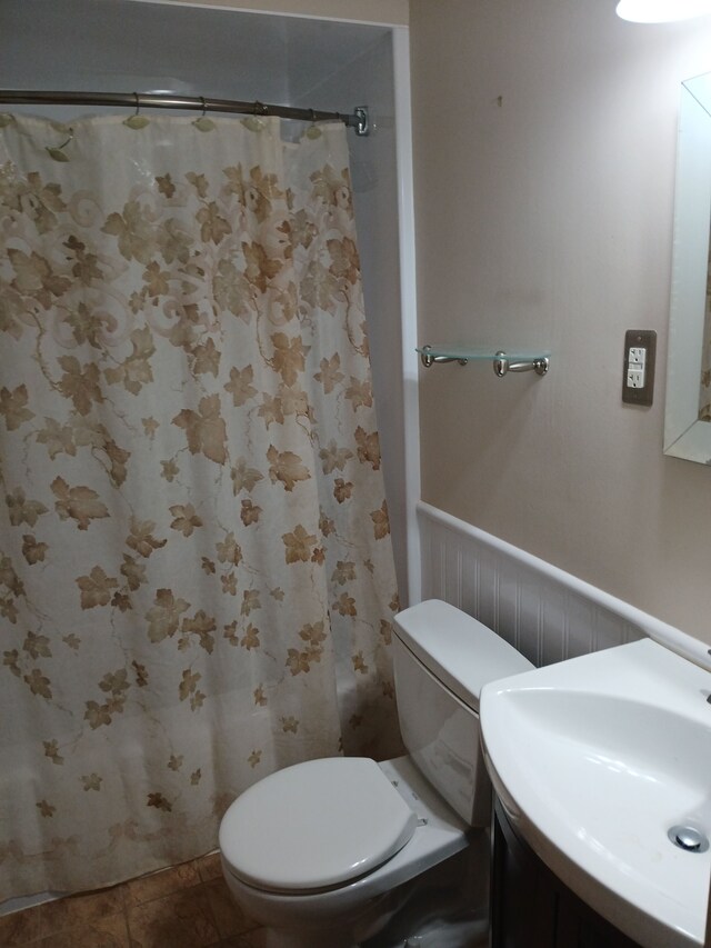 28164 Kendallwood Dr, Farmington Hills, MI 48334 - full bath with toilet, wainscoting, a shower with shower curtain, vanity, and tile patterned floors