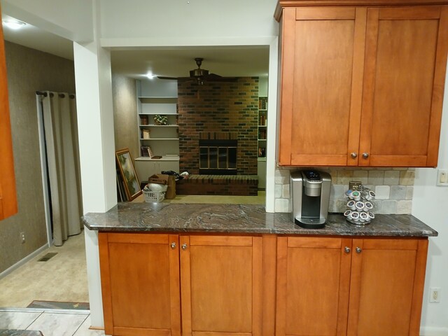 28164 Kendallwood Dr, Farmington Hills, MI 48334 - kitchen featuring a ceiling fan, dark stone countertops, decorative backsplash, and brown cabinetry