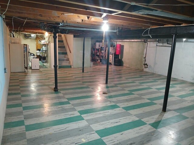 28164 Kendallwood Dr, Farmington Hills, MI 48334 - unfinished basement with tile patterned floors, stairs, and freestanding refrigerator