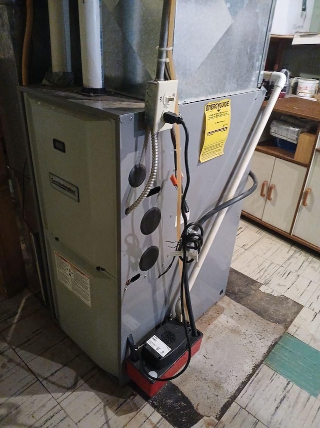 utility room featuring heating unit