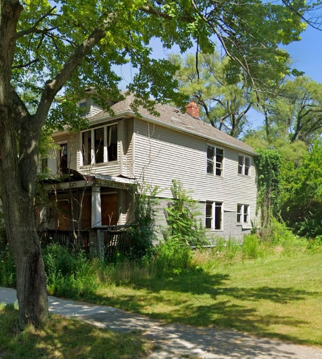 view of side of property with a yard