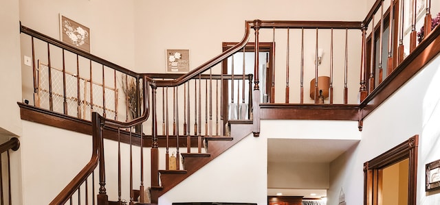 staircase featuring a high ceiling