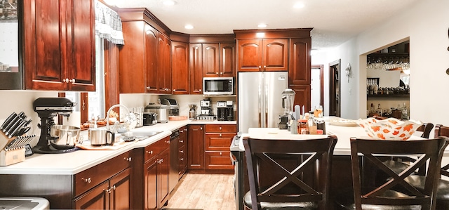 kitchen featuring sink, light wood-type flooring, and stainless steel appliances