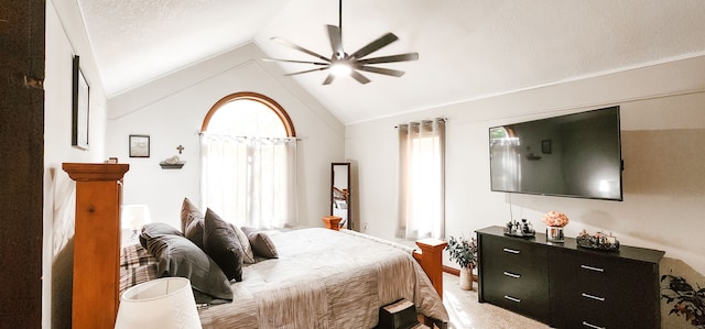 bedroom featuring carpet, ceiling fan, lofted ceiling, and a textured ceiling