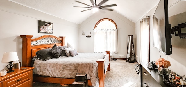 carpeted bedroom with multiple windows, ceiling fan, and lofted ceiling