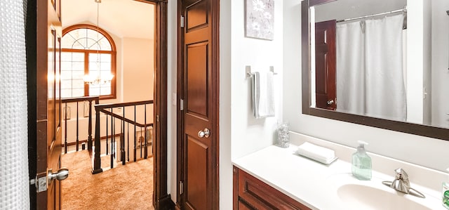 bathroom with vanity and an inviting chandelier