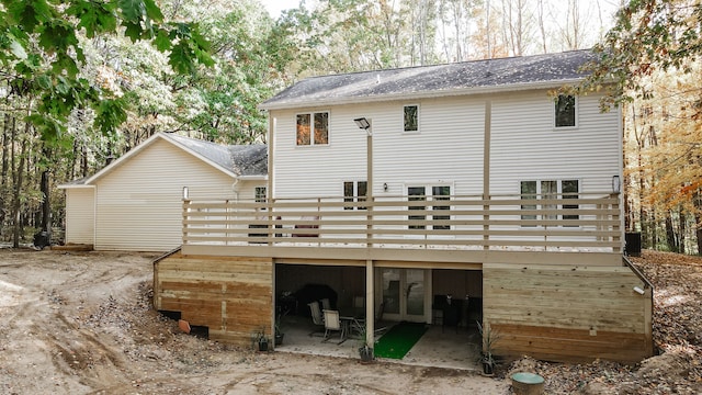 back of property with a wooden deck