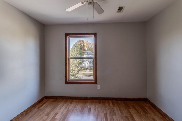 empty room featuring hardwood / wood-style floors and ceiling fan