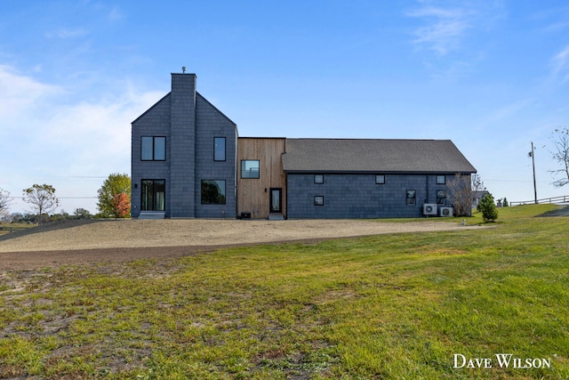 back of property featuring a lawn