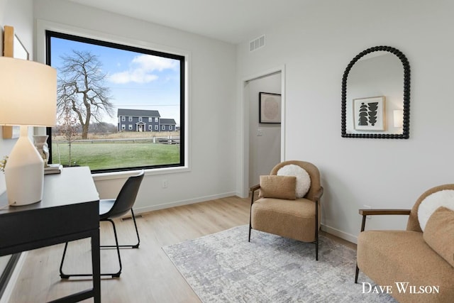 home office with light hardwood / wood-style floors