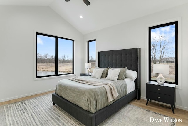 bedroom featuring light wood-type flooring, ceiling fan, and lofted ceiling