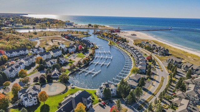 bird's eye view with a water view and a beach view